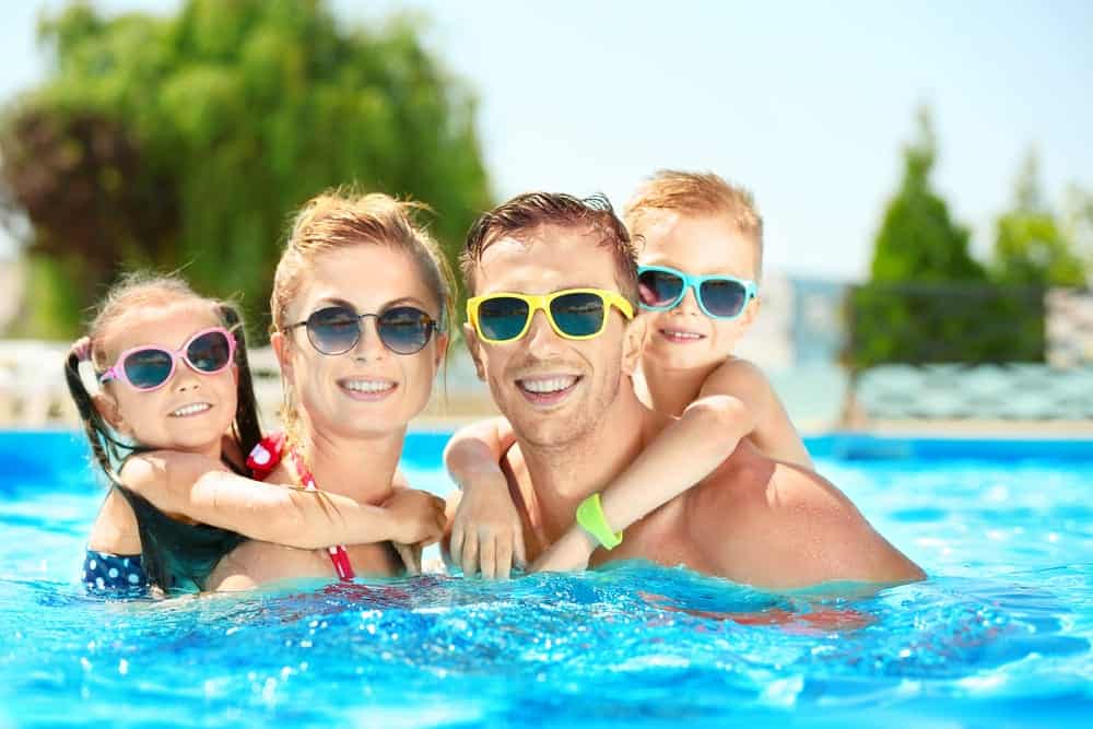 A family enjoying a swimming pool.