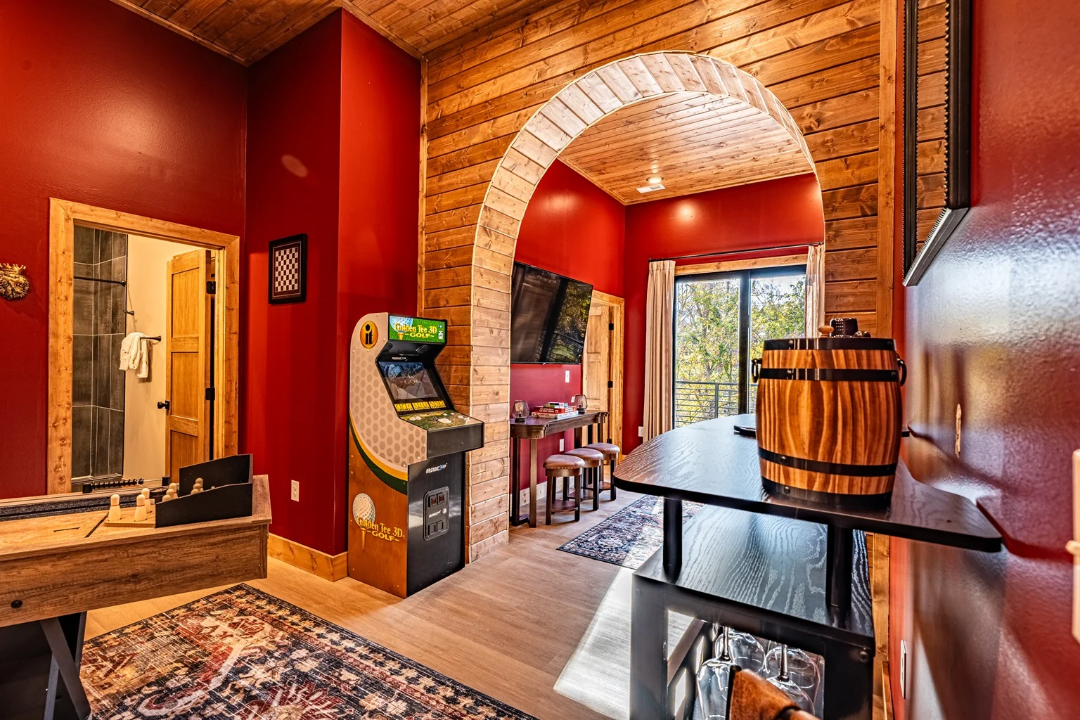Game room with pool table and arcade in a rustic log cabin rental with hot tub in Gatlinburg