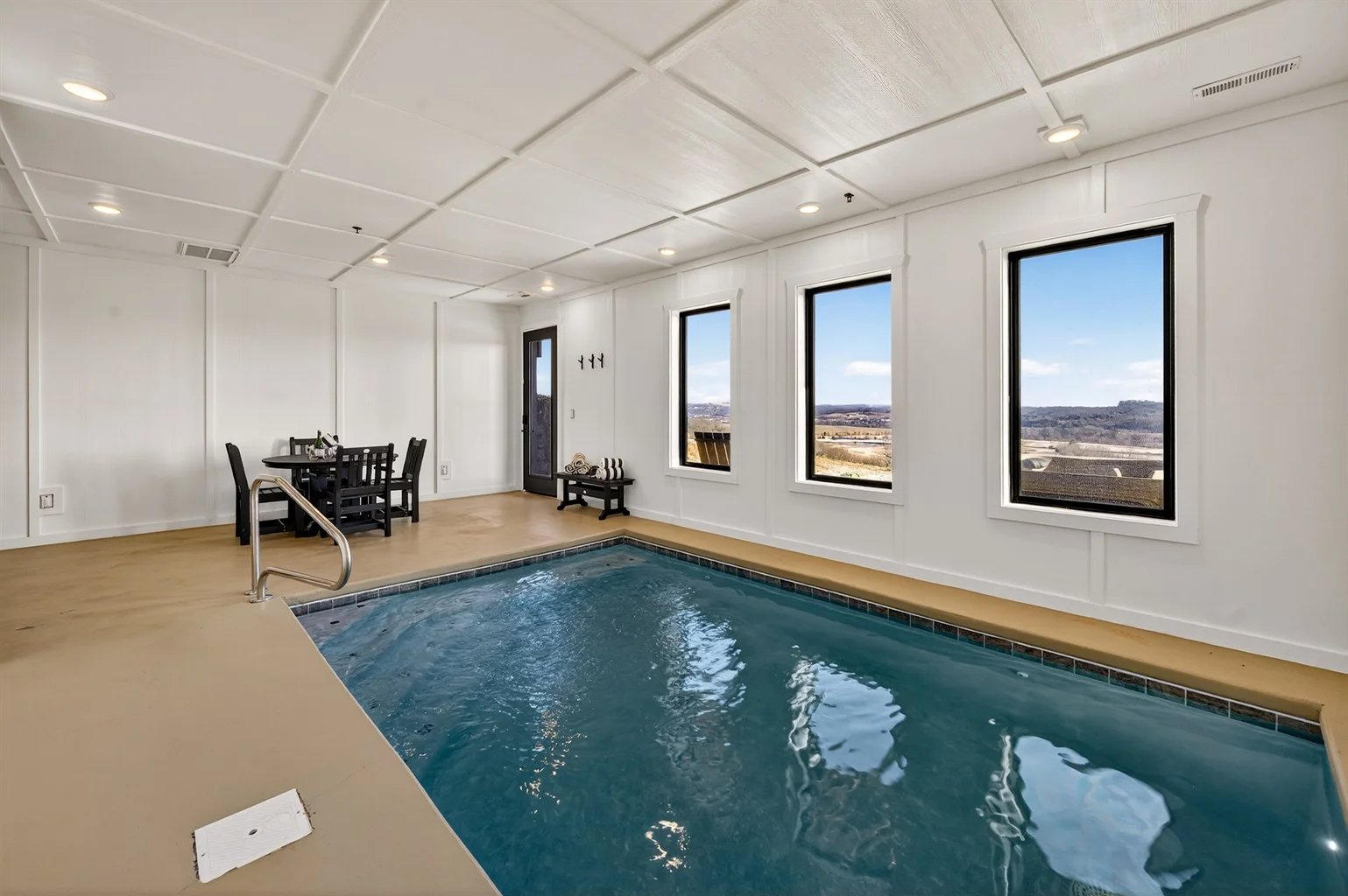 Modern indoor pool with turquoise water and valley views in a Gatlinburg cabin with pool amenities