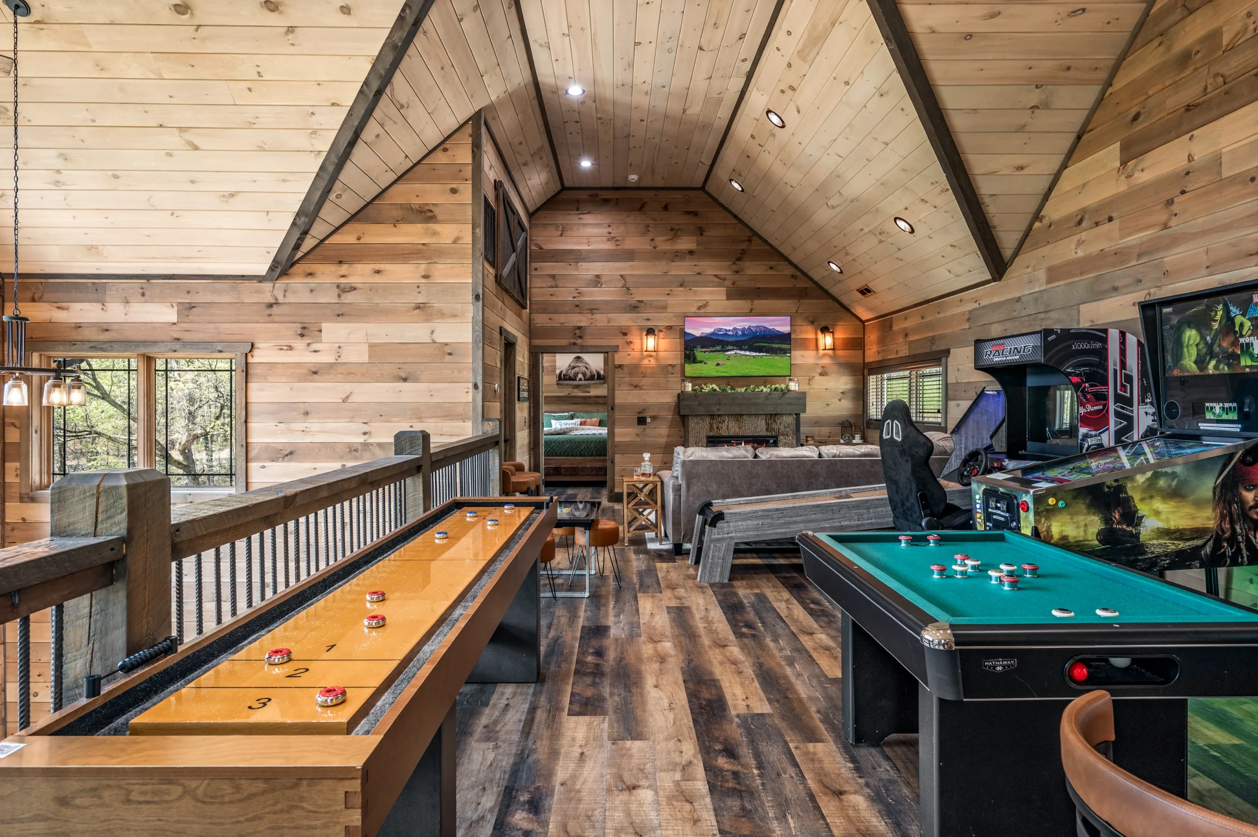 Game room with pool table, shuffleboard, and arcade games in Gatlinburg cabin rental