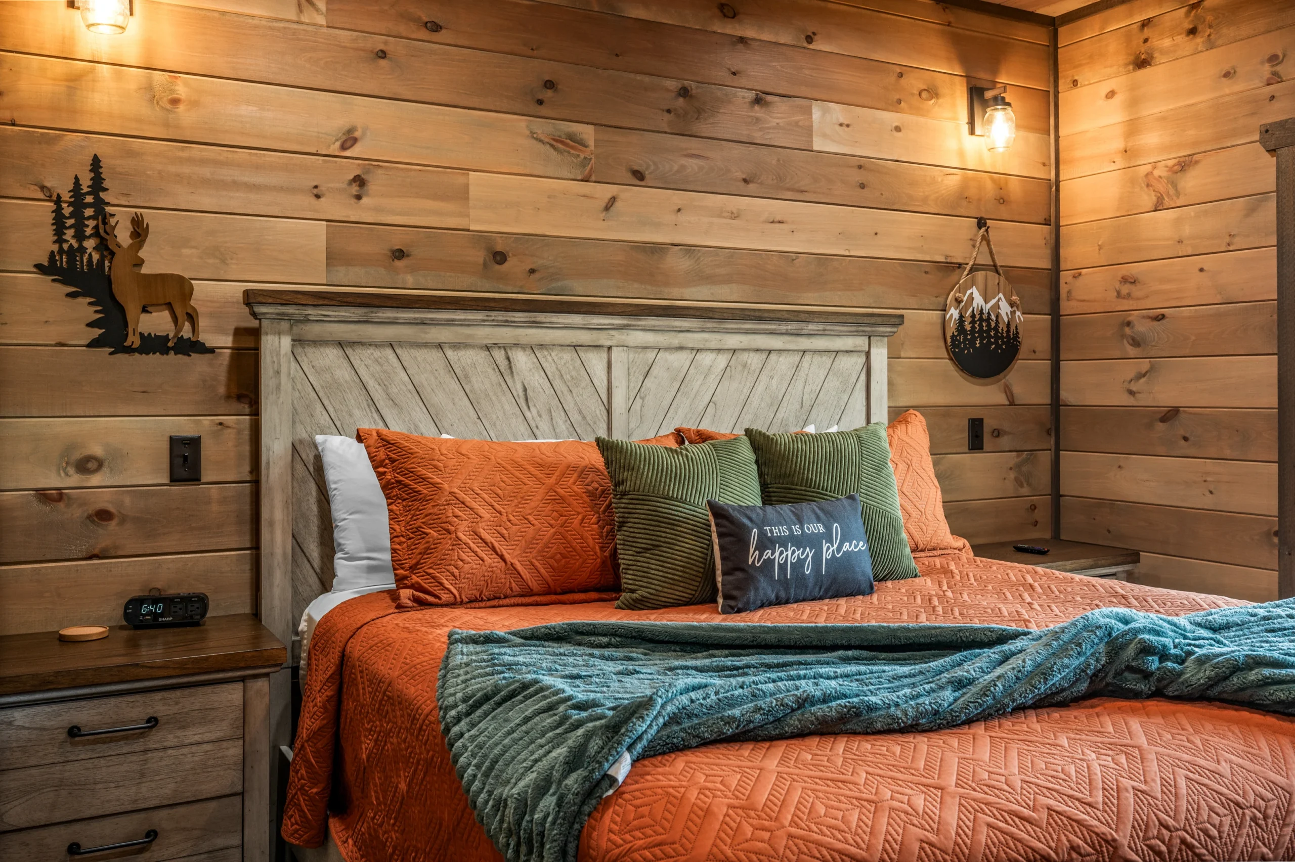 Cozy log cabin bedroom with whitewashed headboard and forest decor in Sevierville, TN