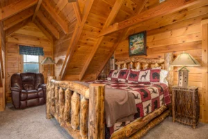 Rustic log cabin bedroom with wildlife bedding and vaulted ceilings in Pigeon Forge