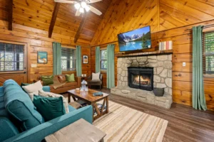 Large group cabin living room with stone fireplace and wood interior in Sevierville