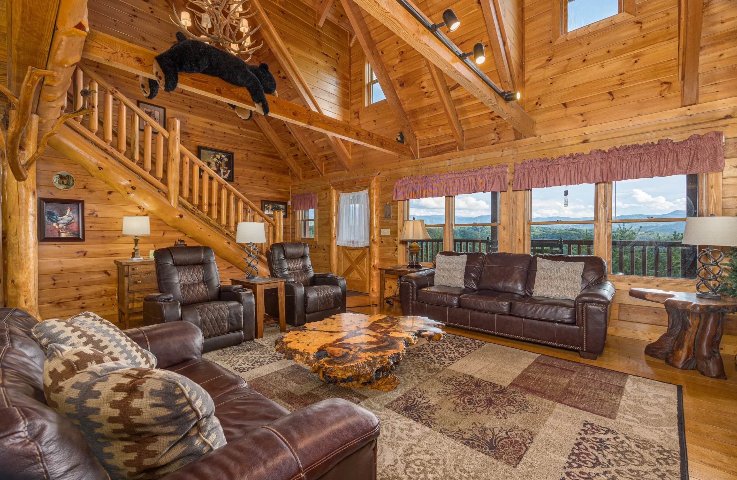 Luxury log cabin living room with vaulted timber ceilings and mountain views in Sevierville