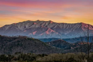 Smoky Mountains sunset view from affordable Gatlinburg cabin with golden light over forested ridges
