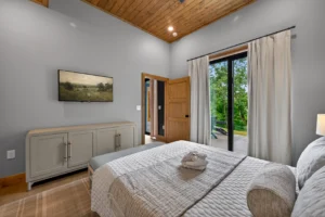 Modern master bedroom with king bed and patio access at 1414 Social in Sevierville, Tennessee