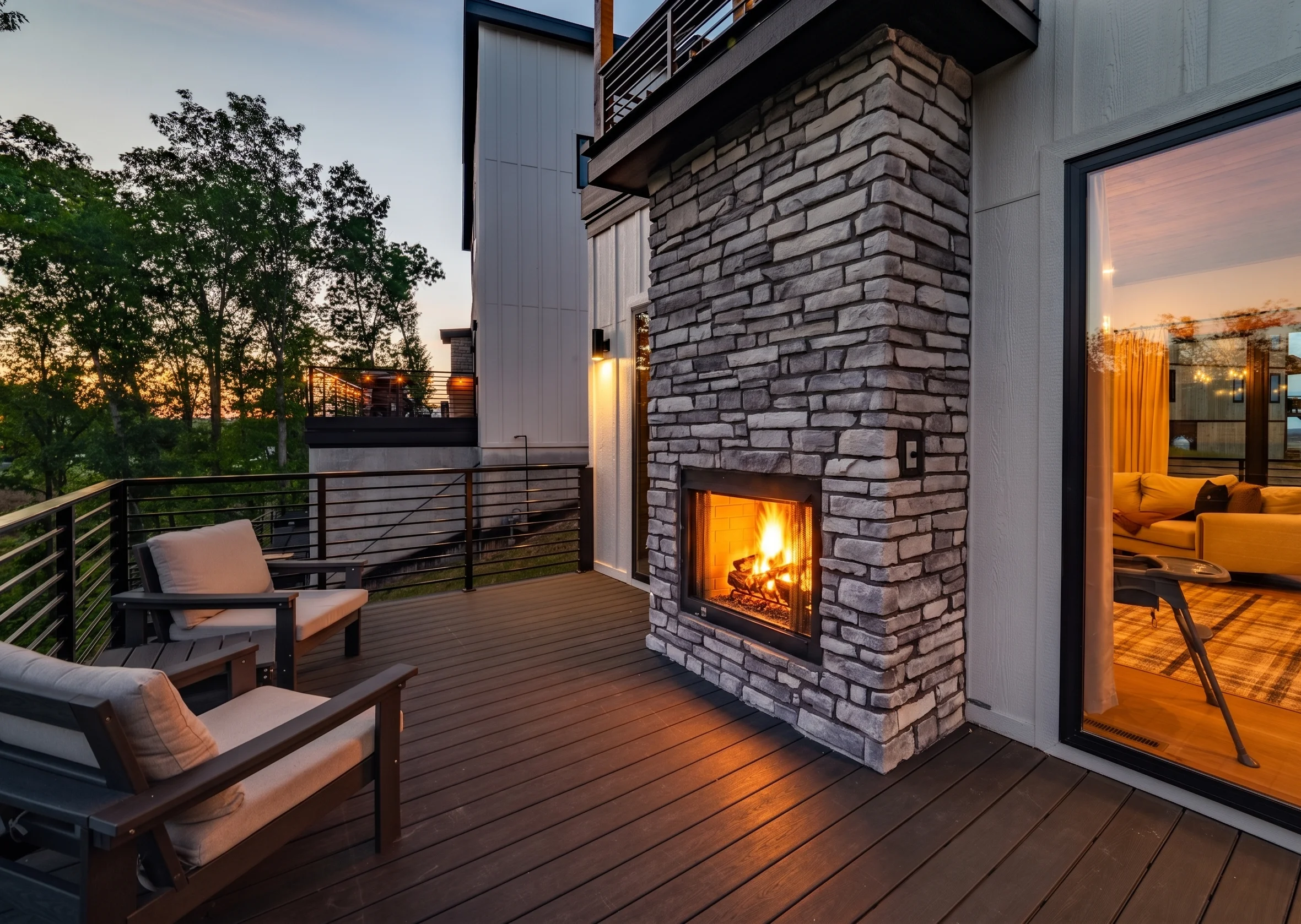 Modern patio with stone fireplace, lounge chairs, and mountain views at 1414 Social Sevierville