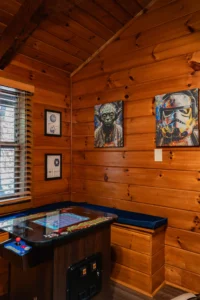 Forest Awakens game room with arcade machine and Star Wars decor in Sevierville cabin