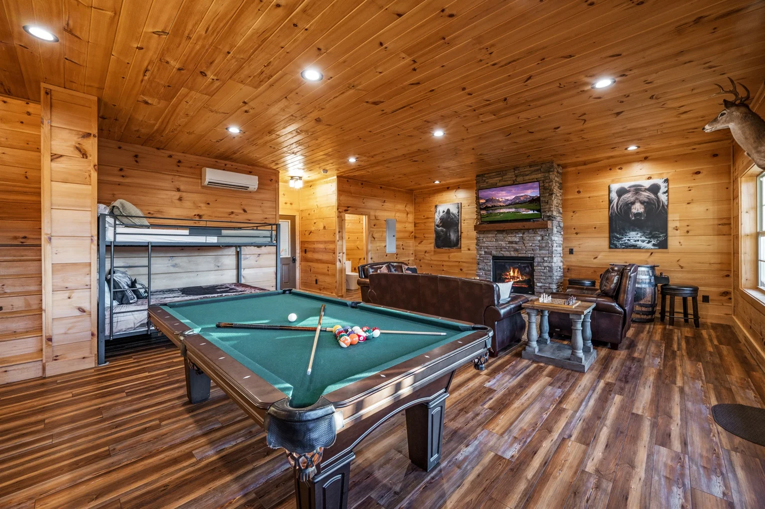 Game room with billiards table and fireplace in Sevierville log cabin rental