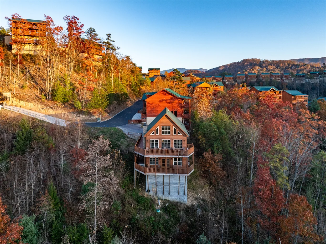 Aerial view of a bear cabin Tennessee rental in Sevierville surrounded by autumn Smoky Mountain forest