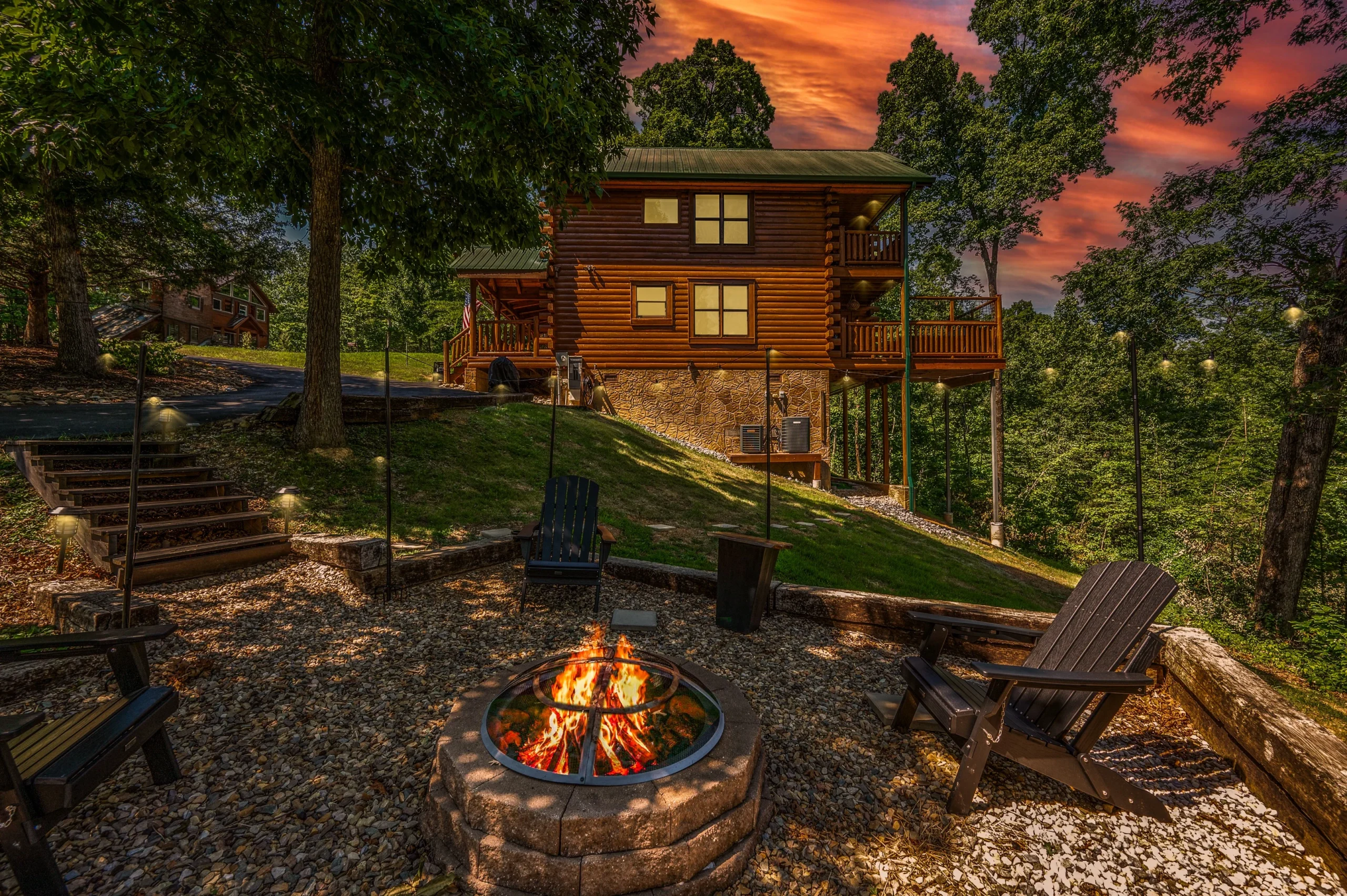 Rustic log cabin exterior with firepit and Adirondack chairs in Sevierville cabins by Dollywood