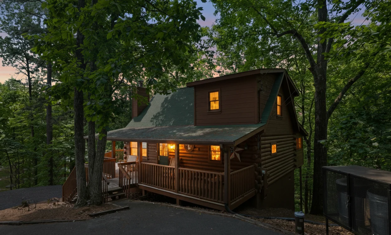 Log cabin near Gatlinburg airport drive route glowing at twilight with wraparound deck