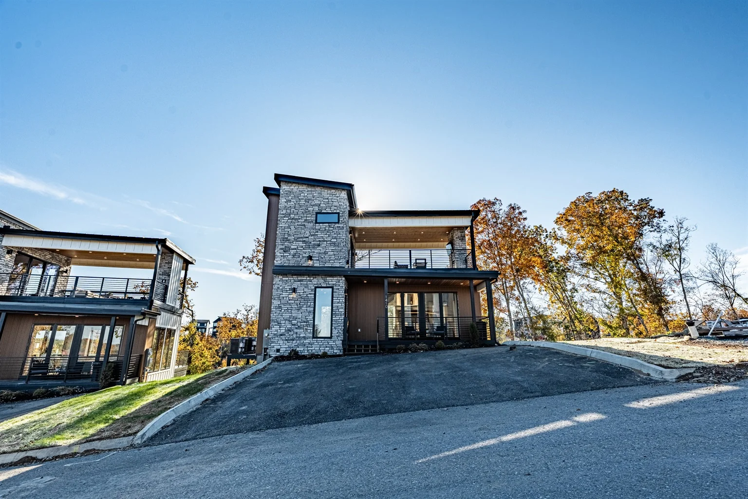 Modern stone exterior of Smoky Mountain Serenity Lodge in Sevierville, Tennessee with mountain deck views