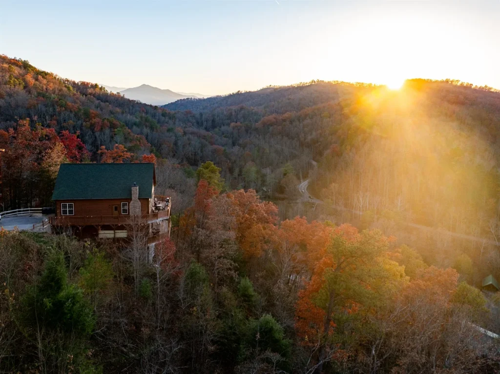 Elevated smoky mountain cabin with hot tub overlooking autumn valleys at sunrise in Sevierville