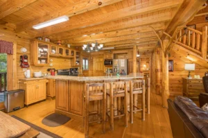 Spacious log cabin kitchen with granite island perfect for anniversary gatherings in Sevierville