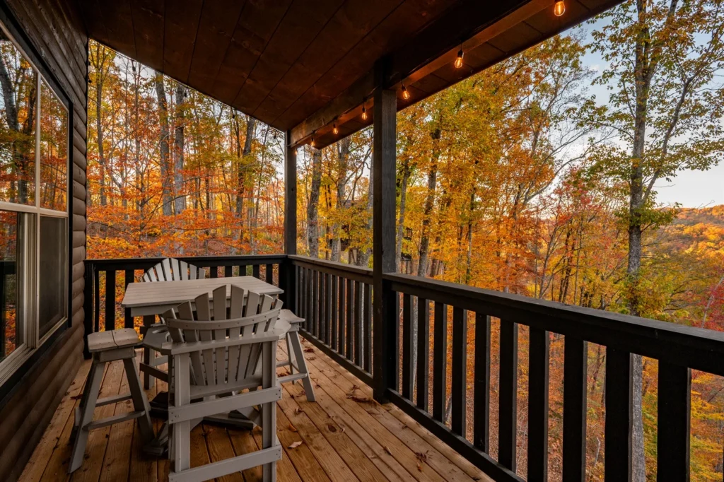 Covered deck with Adirondack chairs overlooking autumn foliage near Sevierville from Gatlinburg