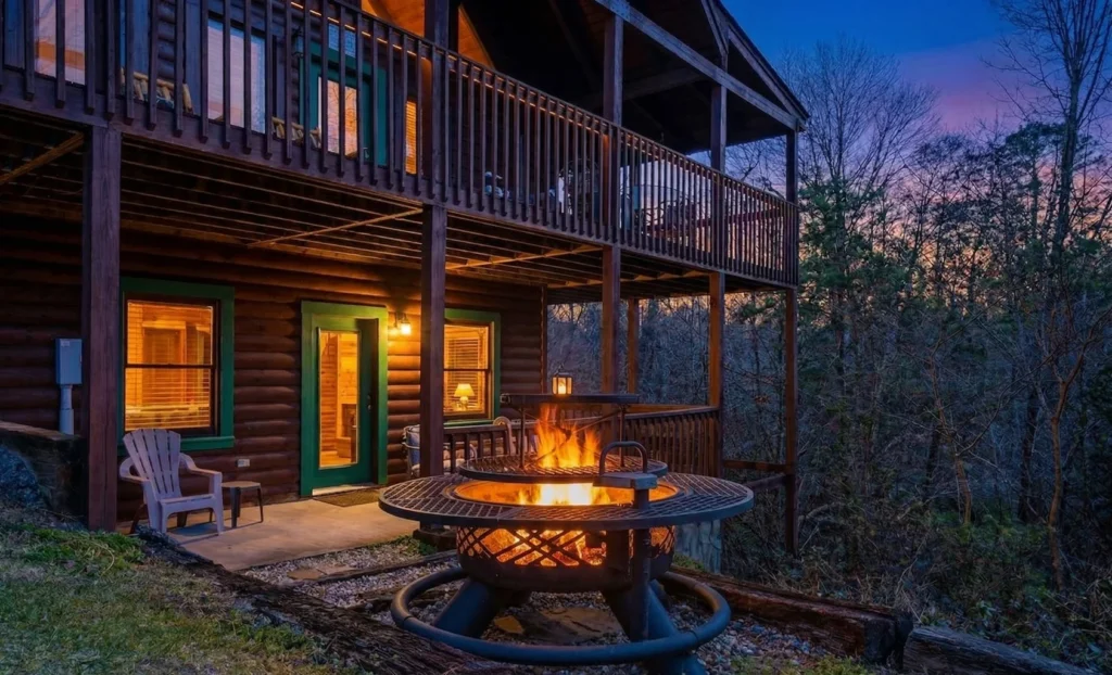 Rustic log cabin exterior with fire pit and multi-level deck in Sevierville, TN