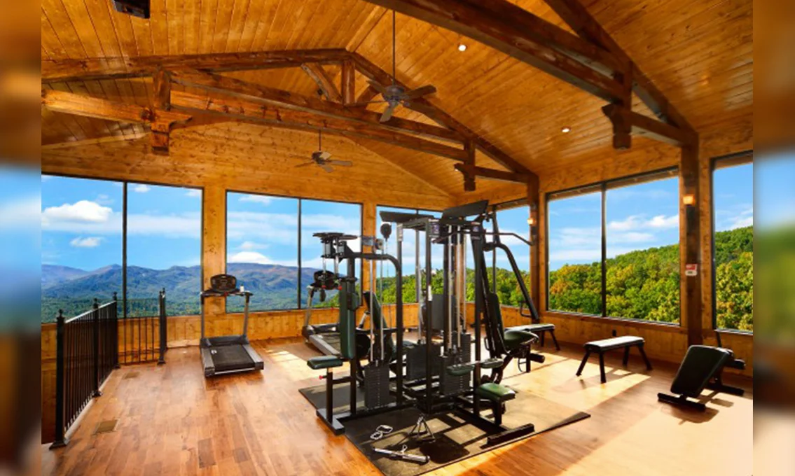 Fitness room with exercise equipment and mountain views in Gatlinburg cabin rental