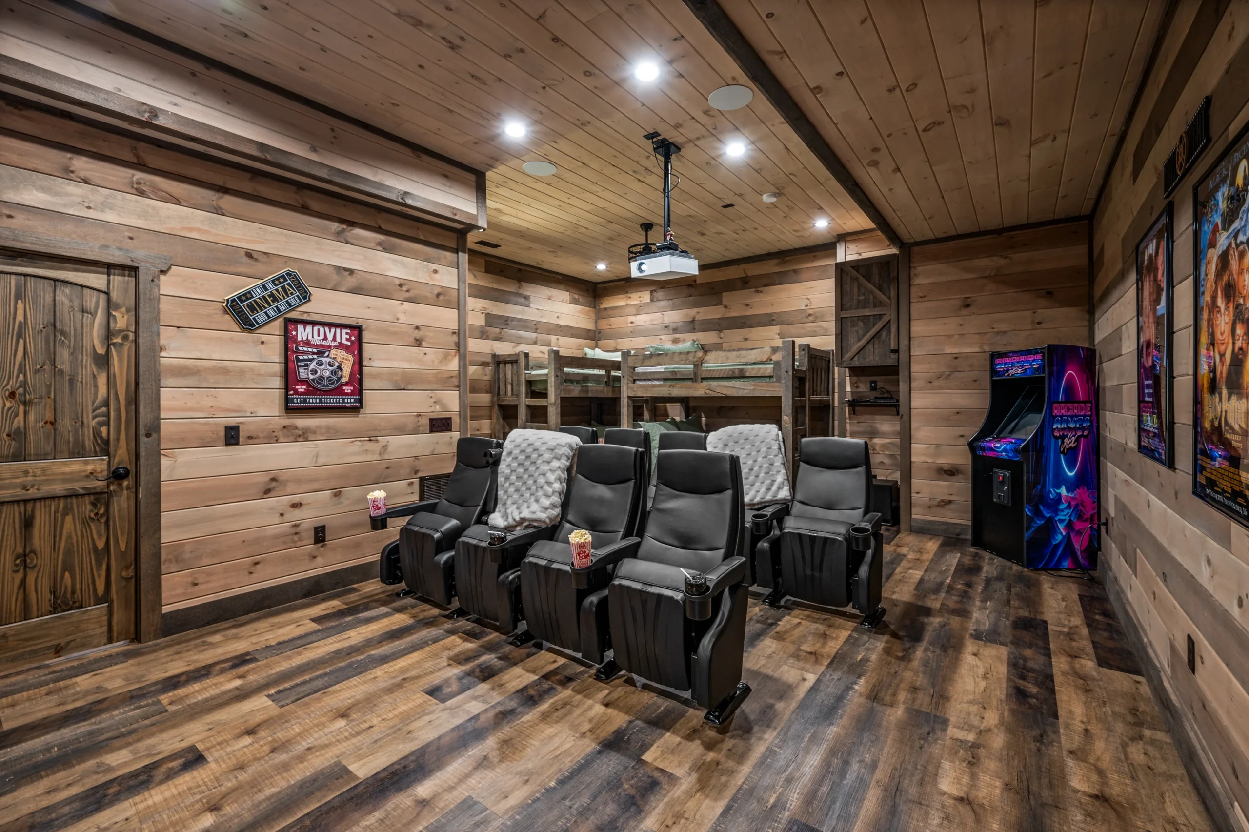 Home theater room with leather recliners and arcade games in Sevierville, TN cabin rental