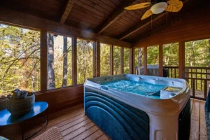 Enclosed hot tub room with forest views at a luxury cabin close to Gatlinburg Tennessee