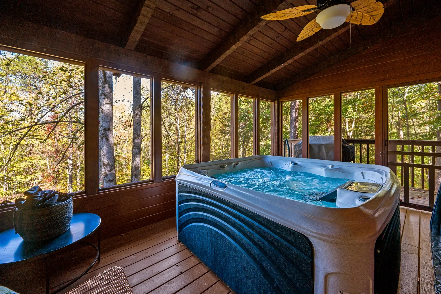Enclosed hot tub room with forest views at a luxury cabin close to Gatlinburg Tennessee