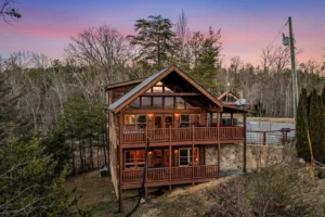 Rustic log cabin exterior with wraparound decks and forest views near Cades Cove in Sevierville