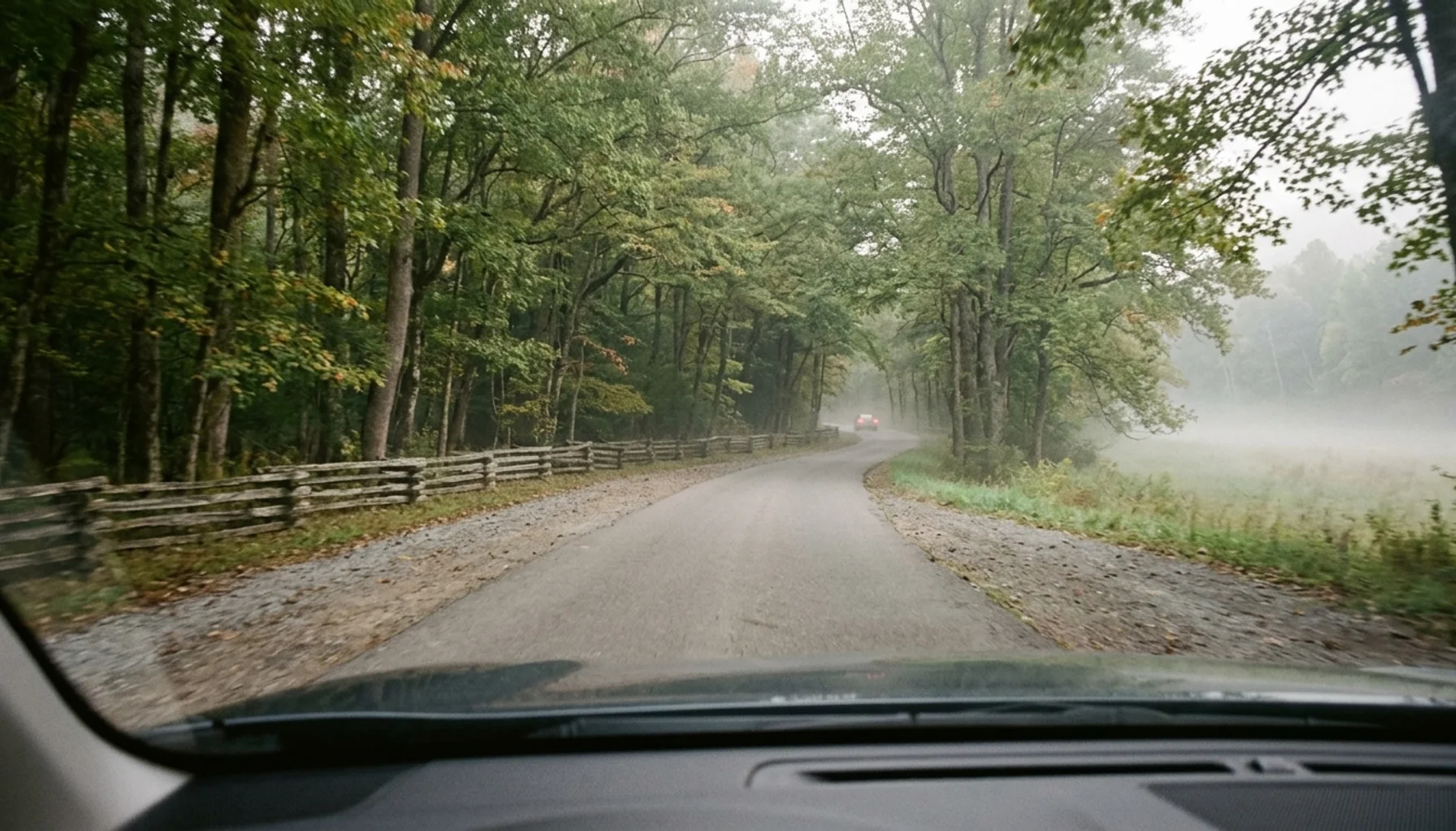 Driving view down the single-lane Cades Cove Loop Road showing how long it takes to drive through Cades Cove
