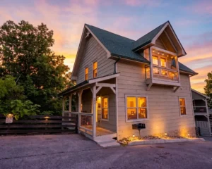 Modern farmhouse vacation rental exterior glowing at dusk in Gatlinburg TN