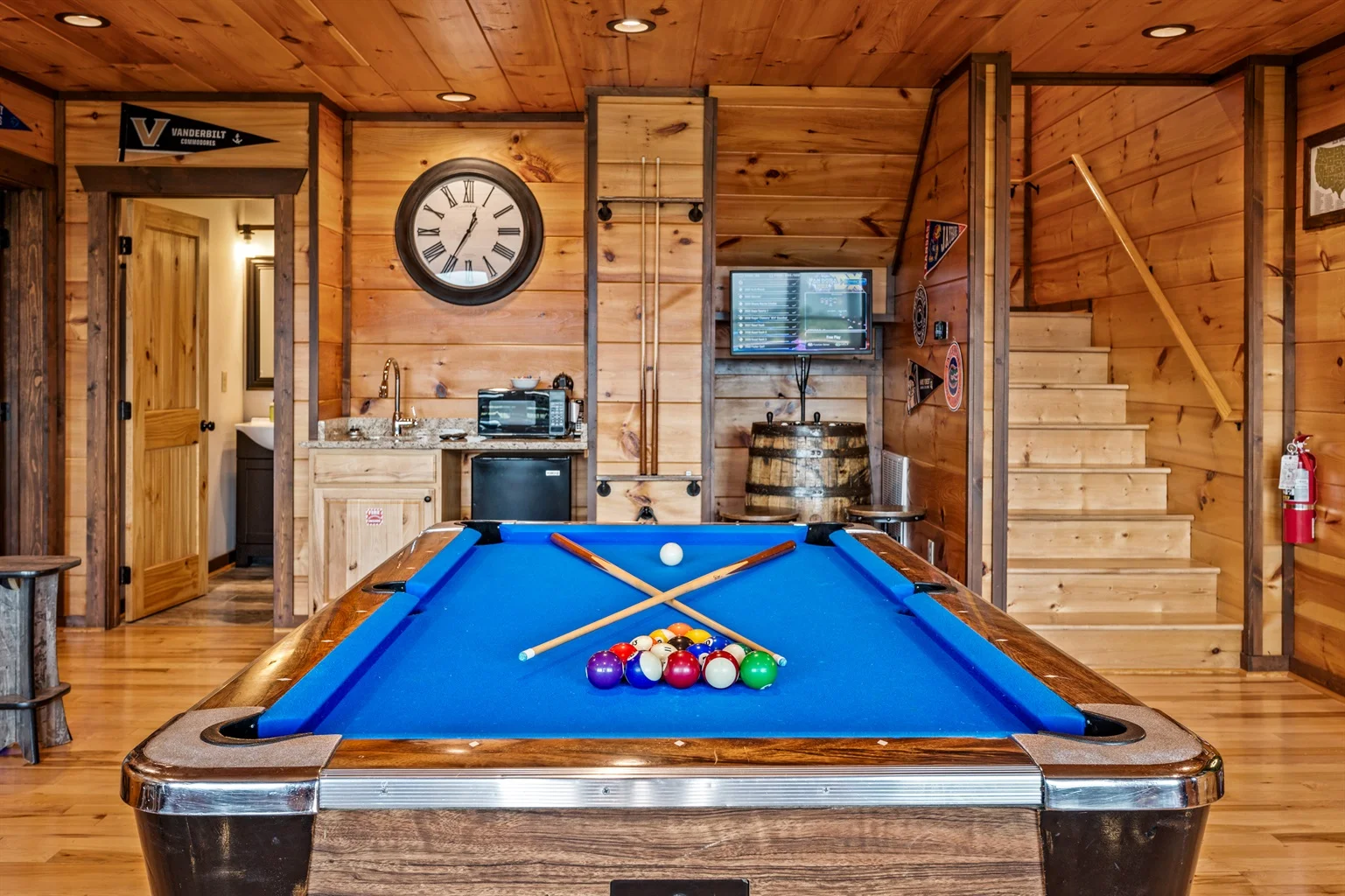 Rustic log cabin game room with pool table and kitchenette in Gatlinburg cabin rental