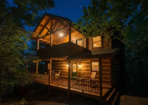 Chase N Moose cabin exterior at dusk with deck, Adirondack chairs, and starlit forest in Gatlinburg