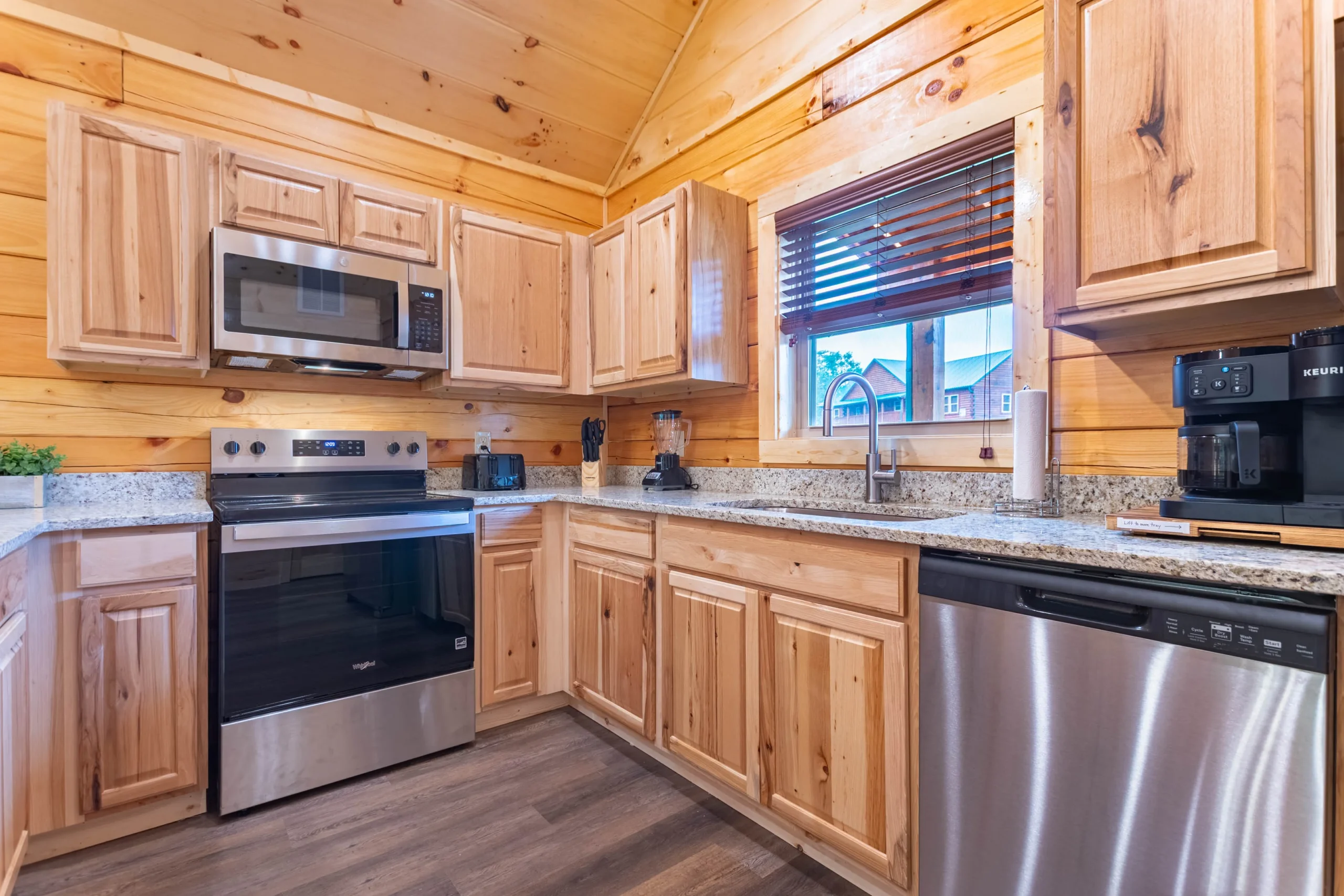 Modern family-friendly vacation rental kitchen in Pigeon Forge with granite countertops, stainless steel appliances, and