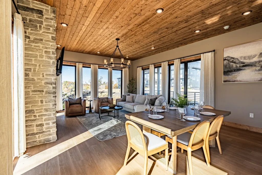 Open-concept living room with stone fireplace and mountain views at a vacation rental by owner in Pigeon Forge TN