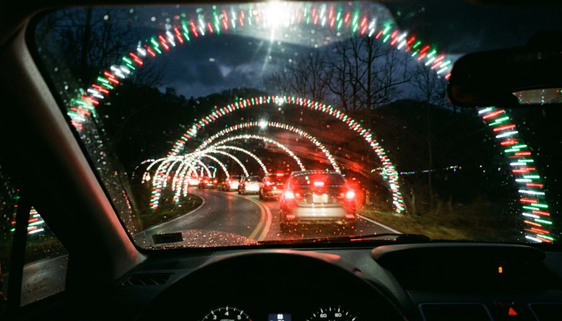 Christmas Never Ends drive-thru light show Pigeon Forge area, light tunnels seen through a car windshield at night