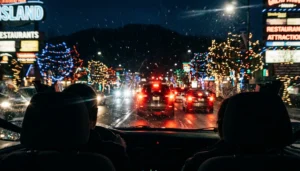 Night view from a car on the Winterfest driving tour of lights Pigeon Forge with snow flurries and blurred colorful displays